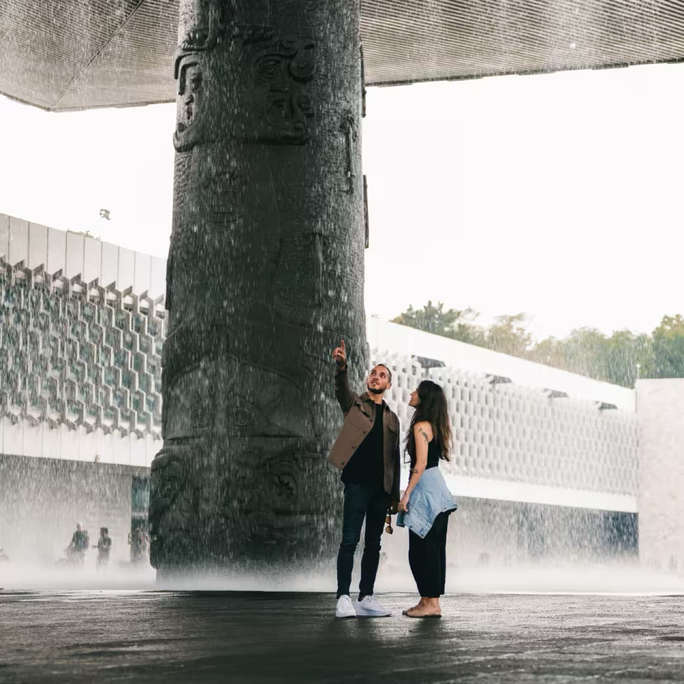 A couple under the umbrella fountain at the National Museum of Anthropology, 450 metres from the house